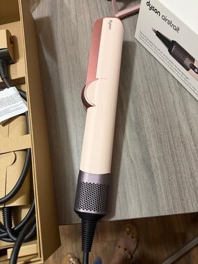 Dyson blush pink and rose gold straightening brush